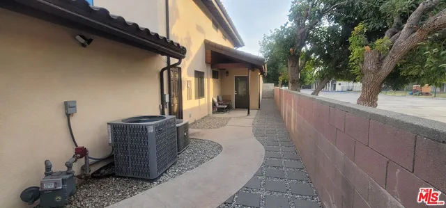 a couple of potted plants sitting in front of a house