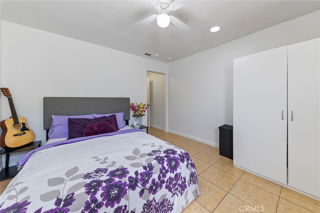 1312 West Commonwealth Avenue Fullerton, CA 92833 - Photo 11 of 39 a bedroom with a bed and a chandelier