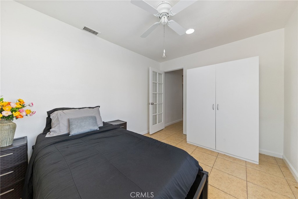 1312 West Commonwealth Avenue Fullerton, CA 92833 - Photo 15 of 39 a bedroom with a bed and a chandelier