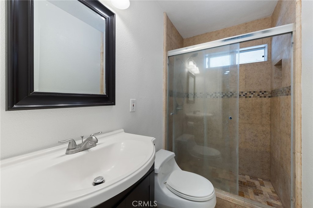 1312 West Commonwealth Avenue Fullerton, CA 92833 - Photo 21 of 39 a bathroom with a sink mirror toilet and shower