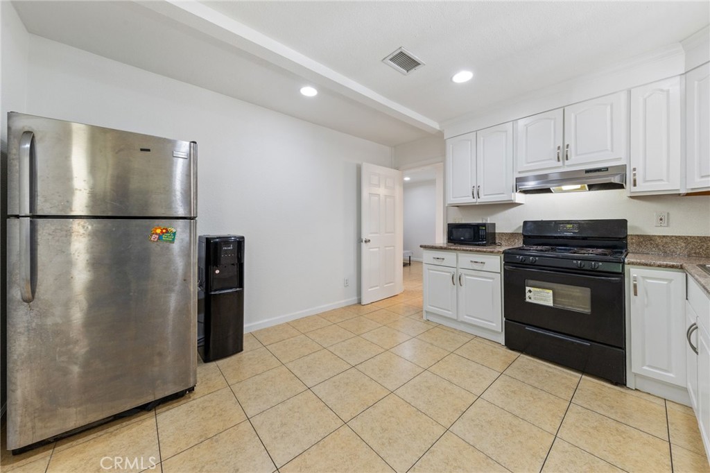 1312 West Commonwealth Avenue Fullerton, CA 92833 - Photo 4 of 39 a kitchen with a white cabinets and white appliances