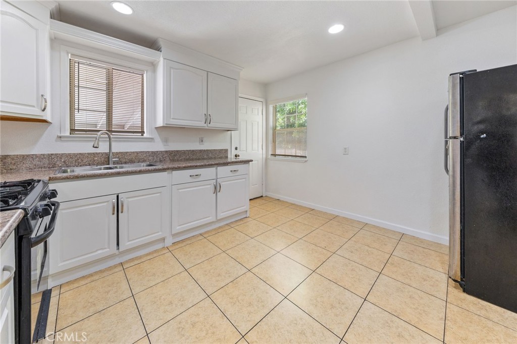 1312 West Commonwealth Avenue Fullerton, CA 92833 - Photo 6 of 39 a kitchen with a sink a window and cabinets