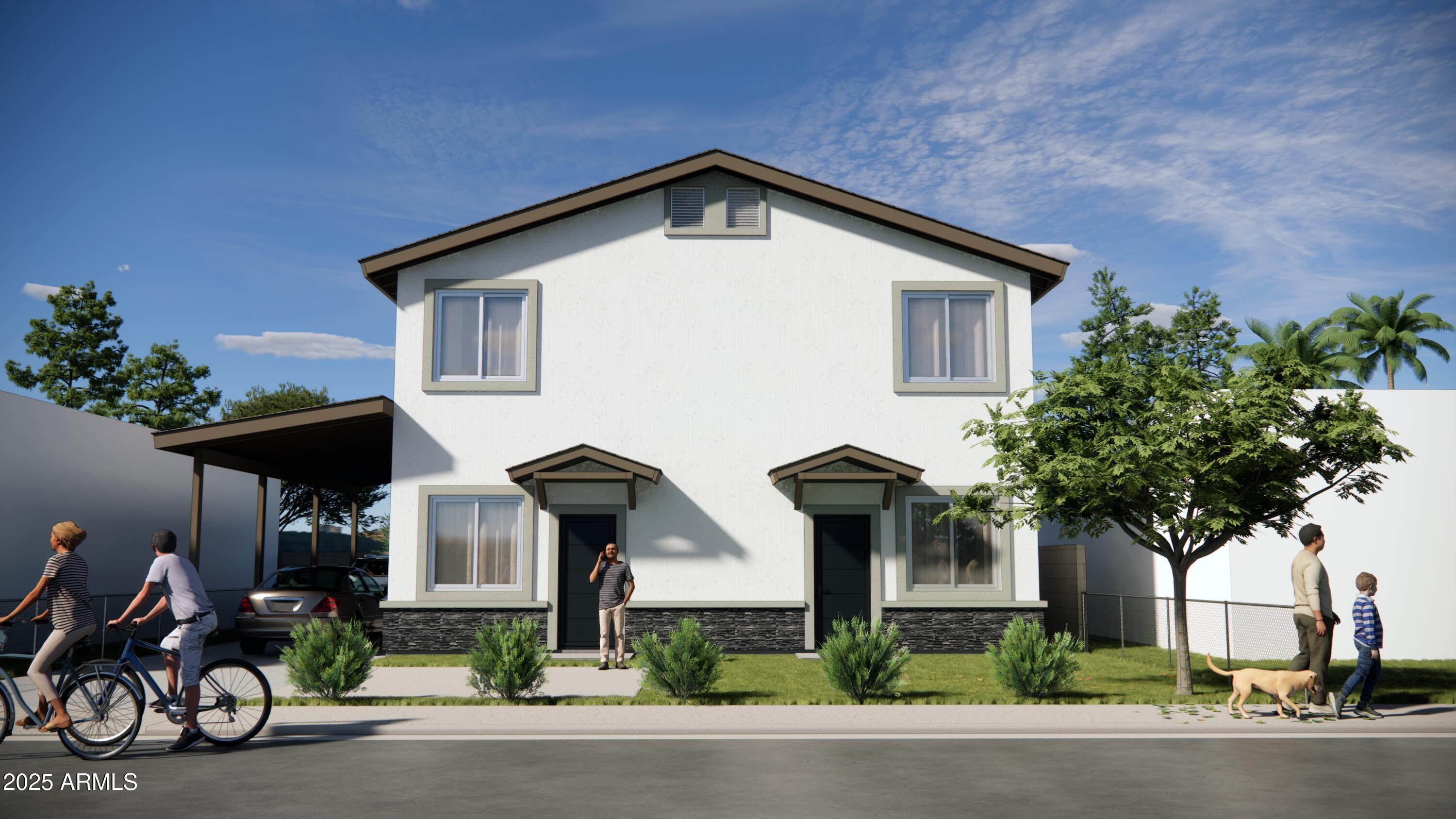 a front view of house with yard outdoor seating and trees in the background