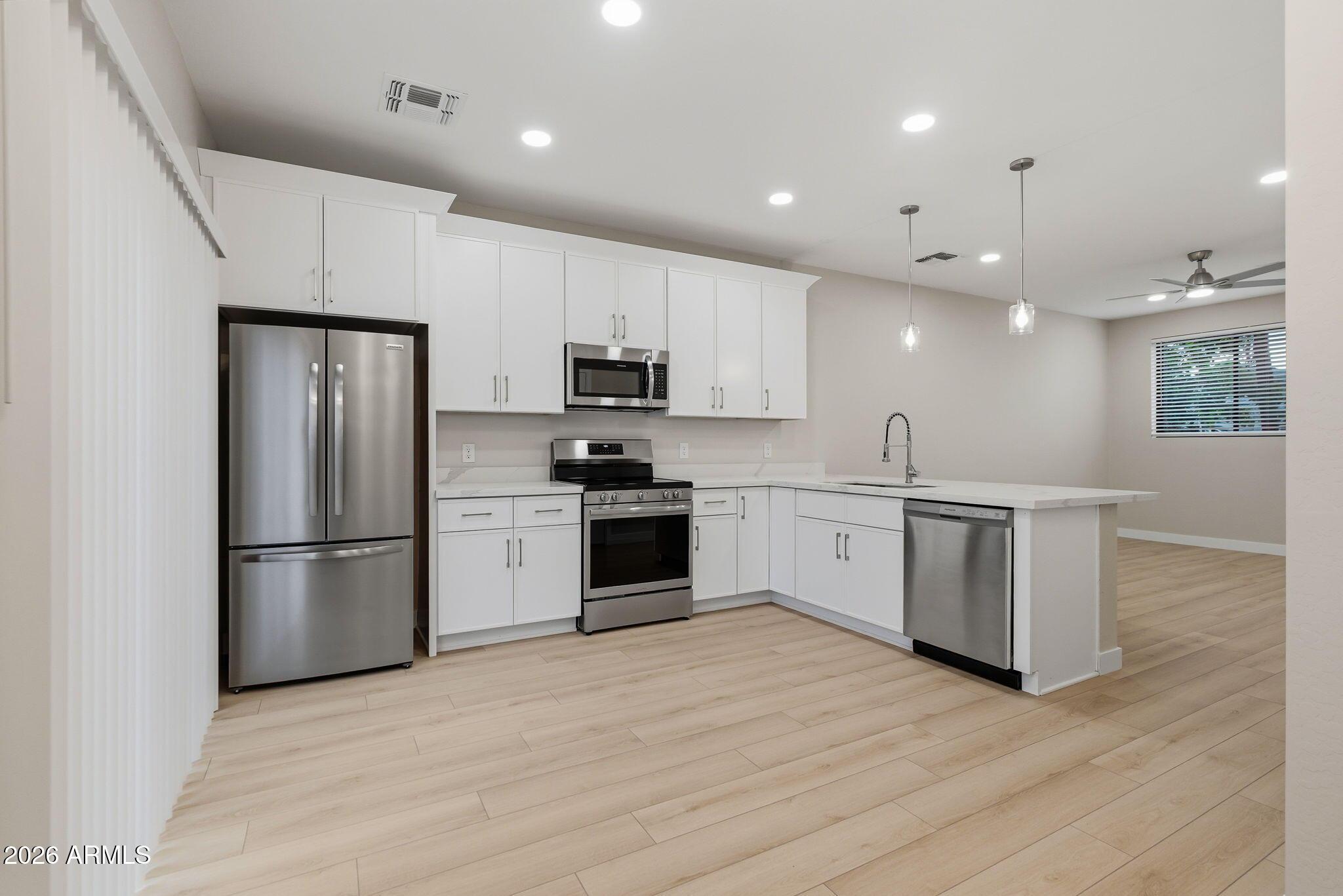 1222 East Diamond Street, Unit 2 Phoenix, AZ 85006 - Photo 11 of 35 a kitchen with a refrigerator and a stove top oven