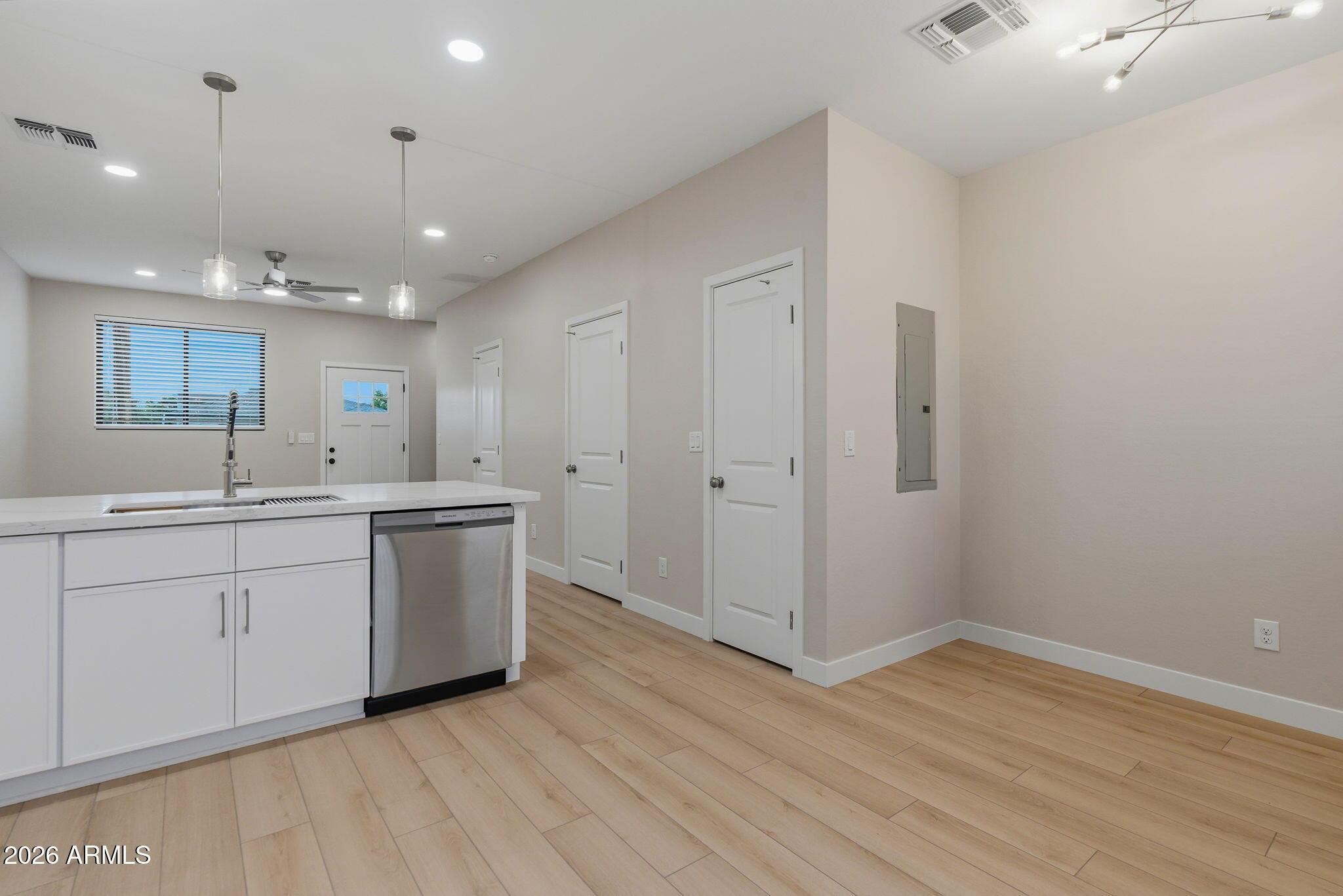 1222 East Diamond Street, Unit 2 Phoenix, AZ 85006 - Photo 13 of 35 a view of a kitchen with a sink and dishwasher with wooden floor