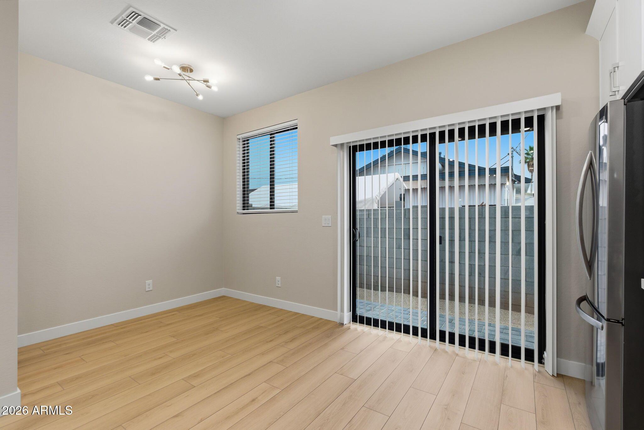 1222 East Diamond Street, Unit 2 Phoenix, AZ 85006 - Photo 16 of 35 a view of an empty room with wooden floor and a window