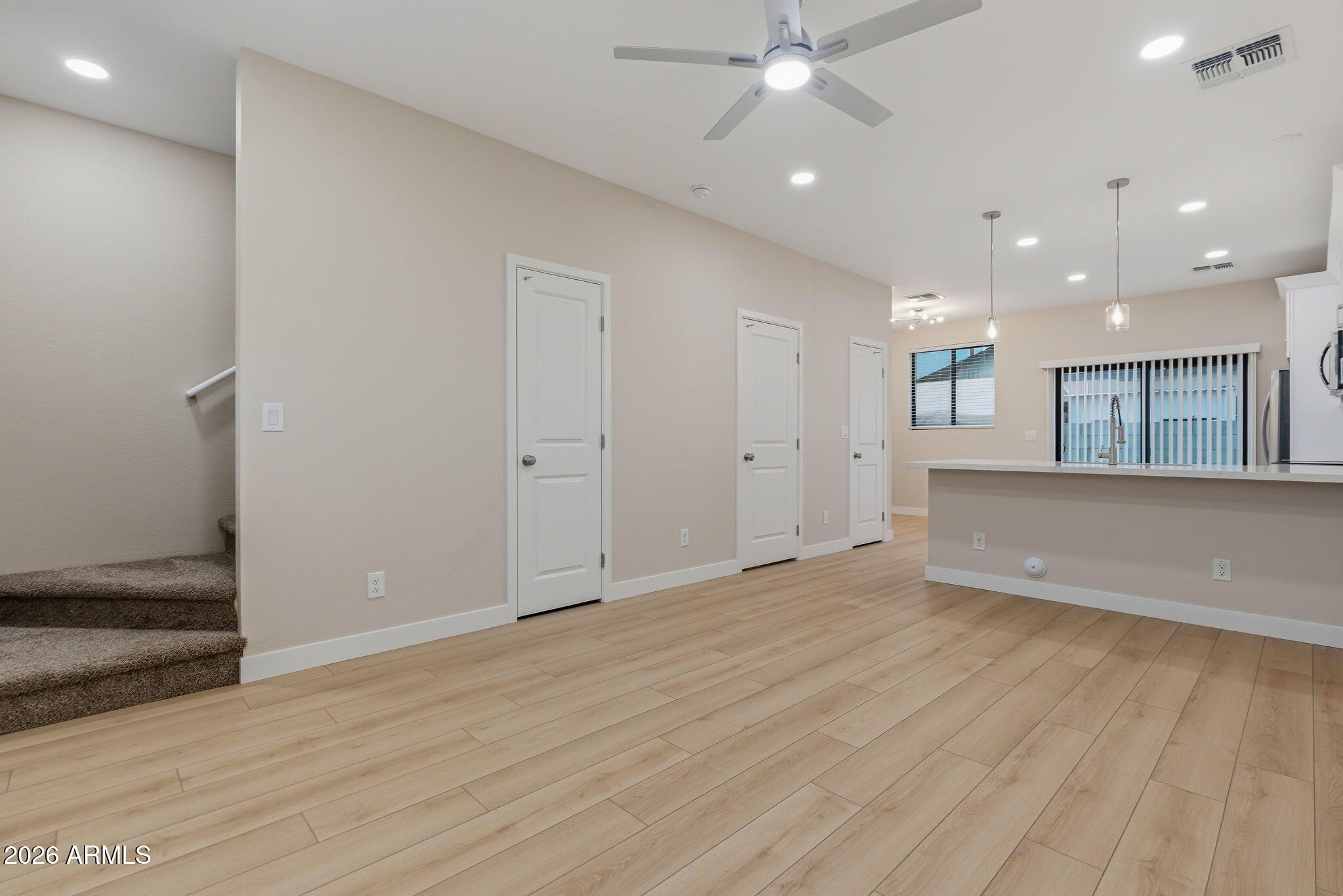 1222 East Diamond Street, Unit 2 Phoenix, AZ 85006 - Photo 2 of 35 an empty room with wooden floor and windows