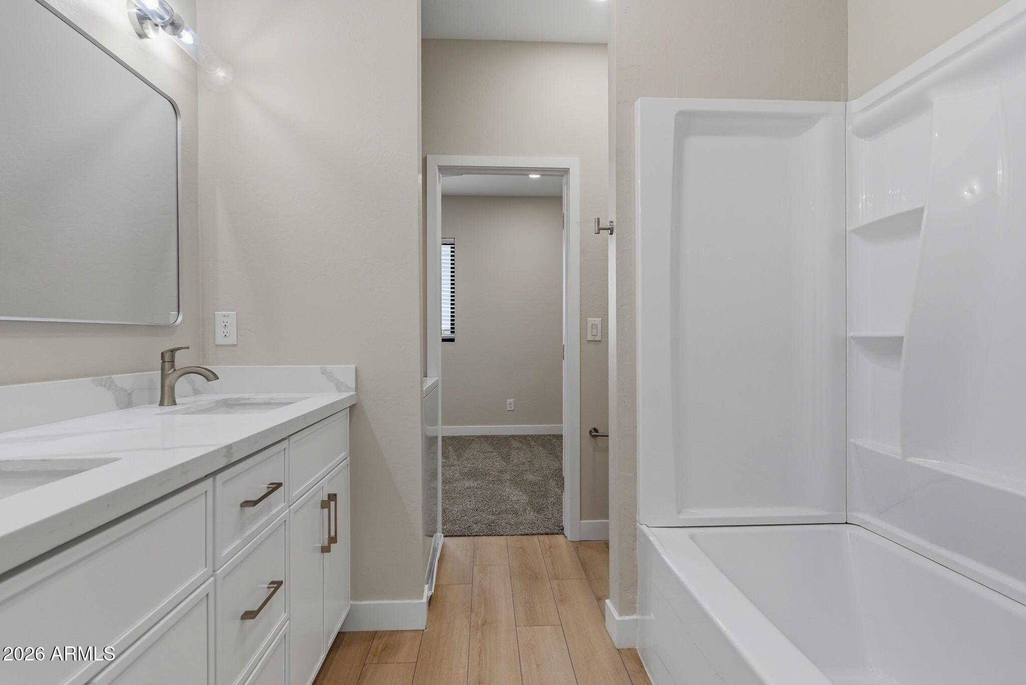 1222 East Diamond Street, Unit 2 Phoenix, AZ 85006 - Photo 25 of 35 a bathroom with a granite countertop sink a toilet and shower