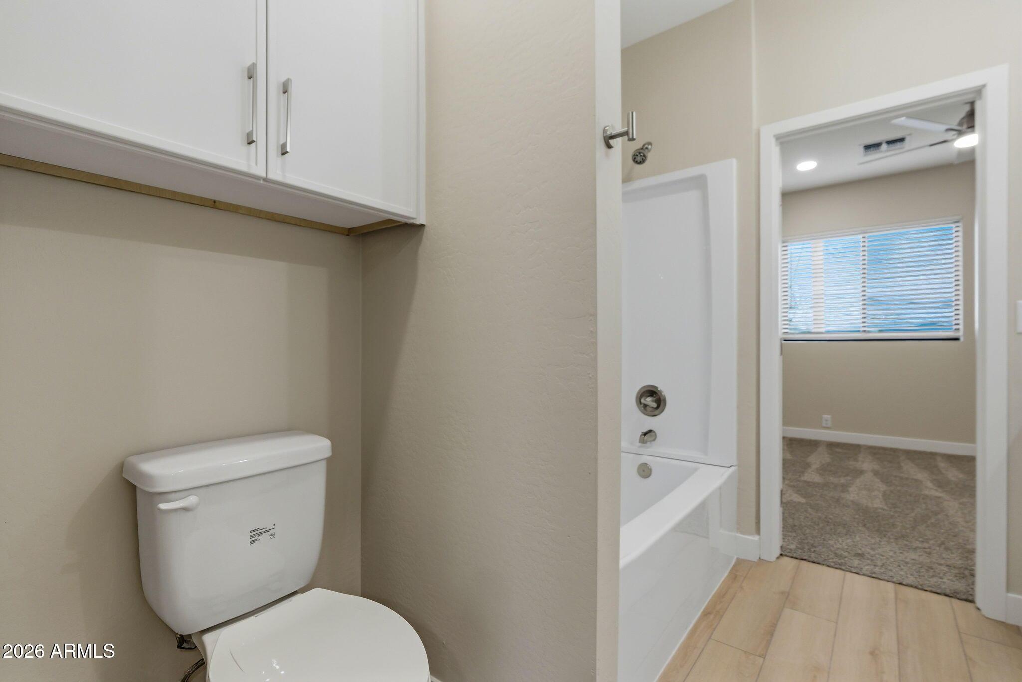 1222 East Diamond Street, Unit 2 Phoenix, AZ 85006 - Photo 29 of 35 a white toilet sitting next to a bathroom sink