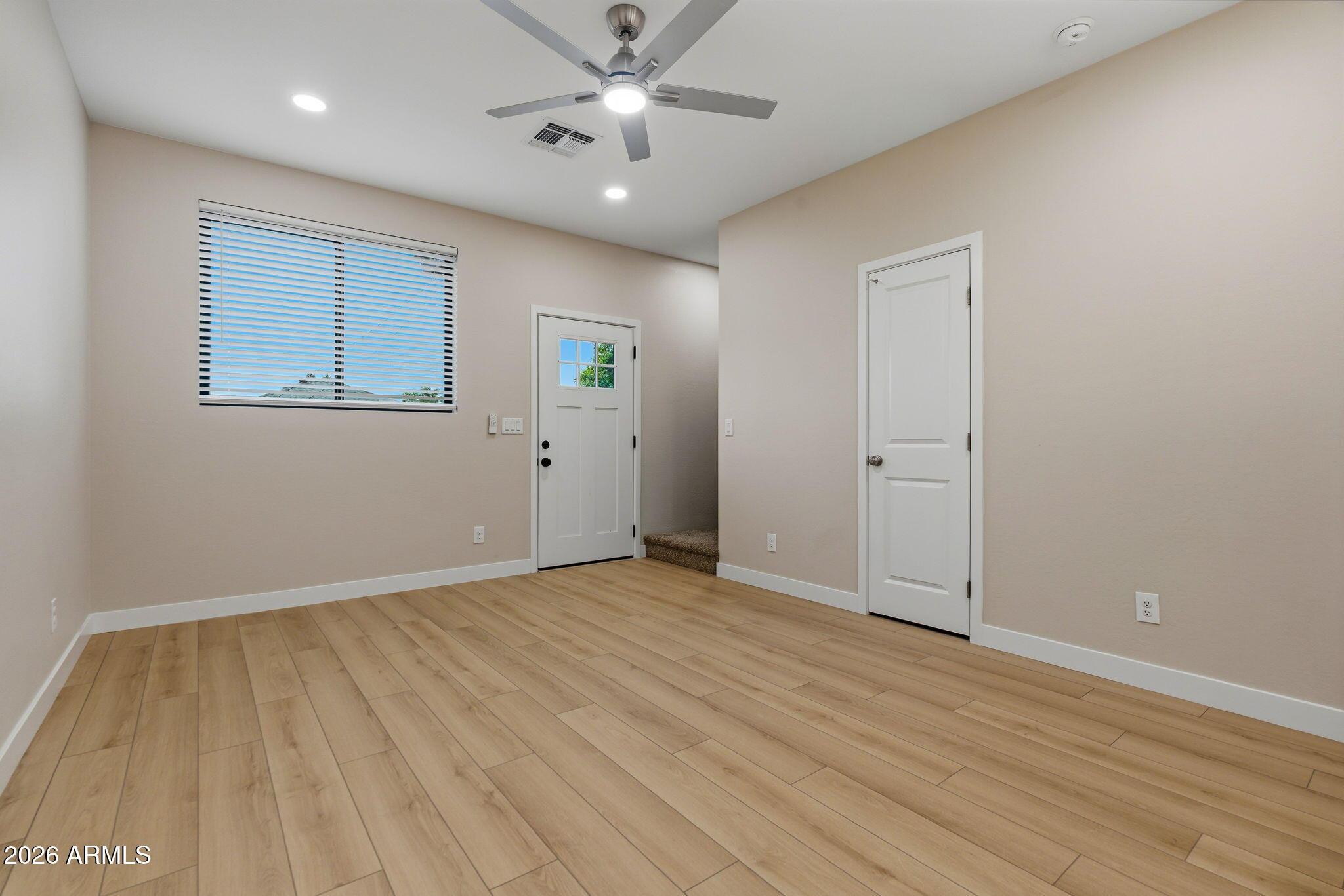1222 East Diamond Street, Unit 2 Phoenix, AZ 85006 - Photo 3 of 35 wooden floor in an empty room with a window
