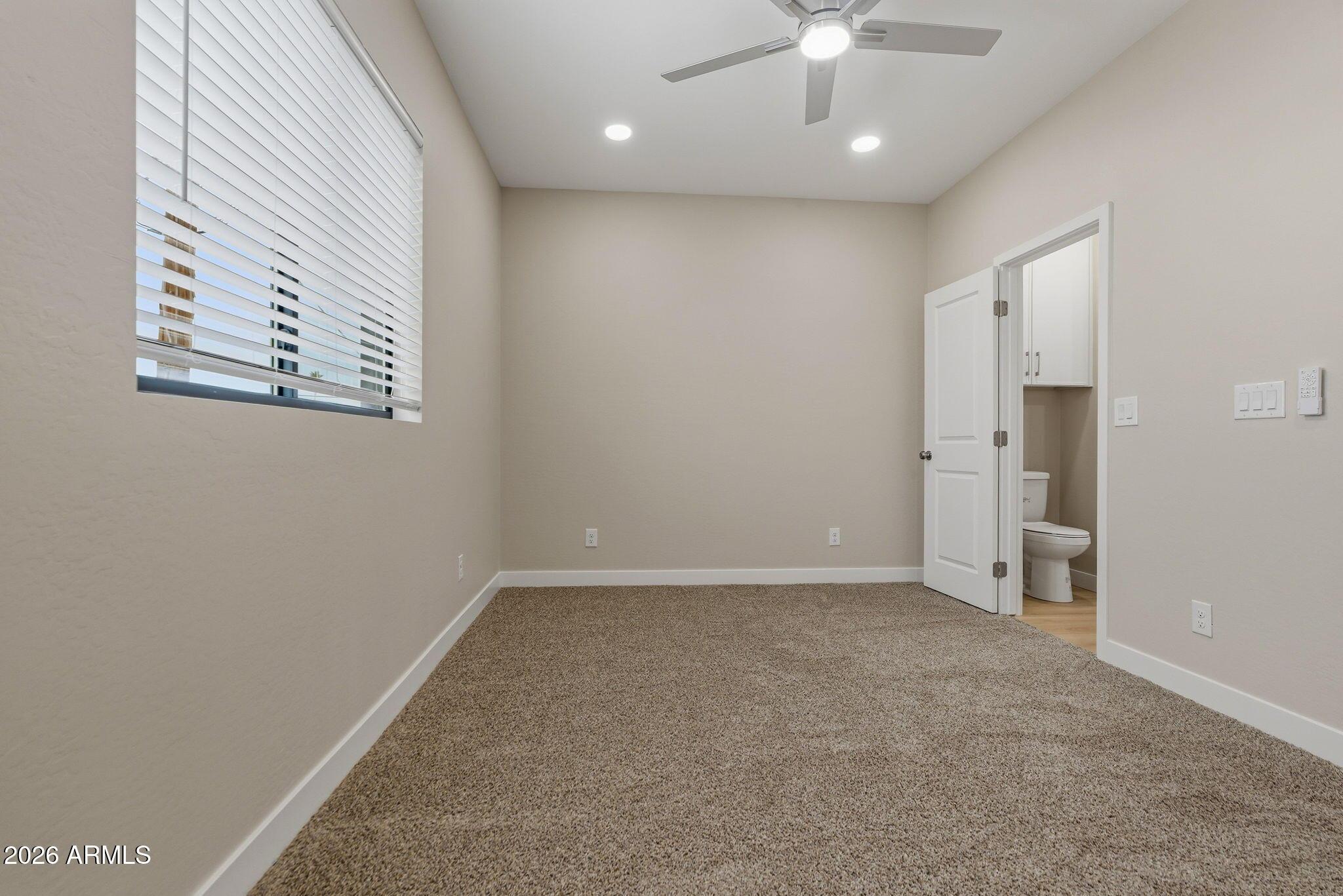 1222 East Diamond Street, Unit 2 Phoenix, AZ 85006 - Photo 33 of 35 an empty room with closet and a ceiling fan