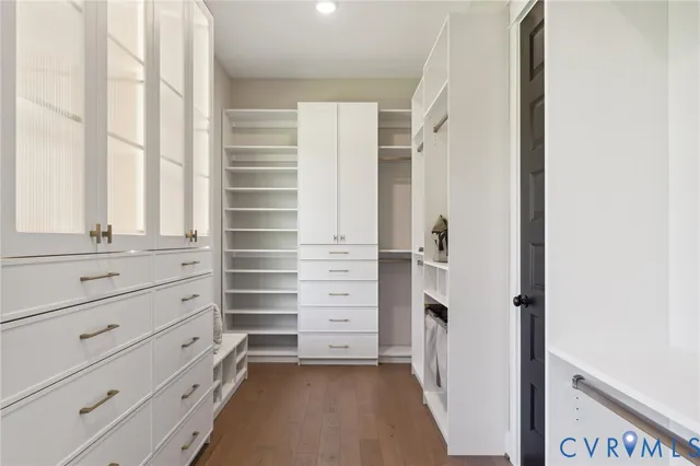 a view of walk in closet with empty racks