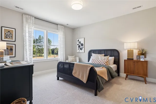 a spacious bedroom with a bed and a window