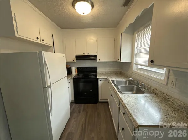 a kitchen with a refrigerator sink and stove