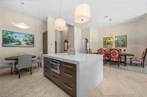 a large kitchen with a table and chairs