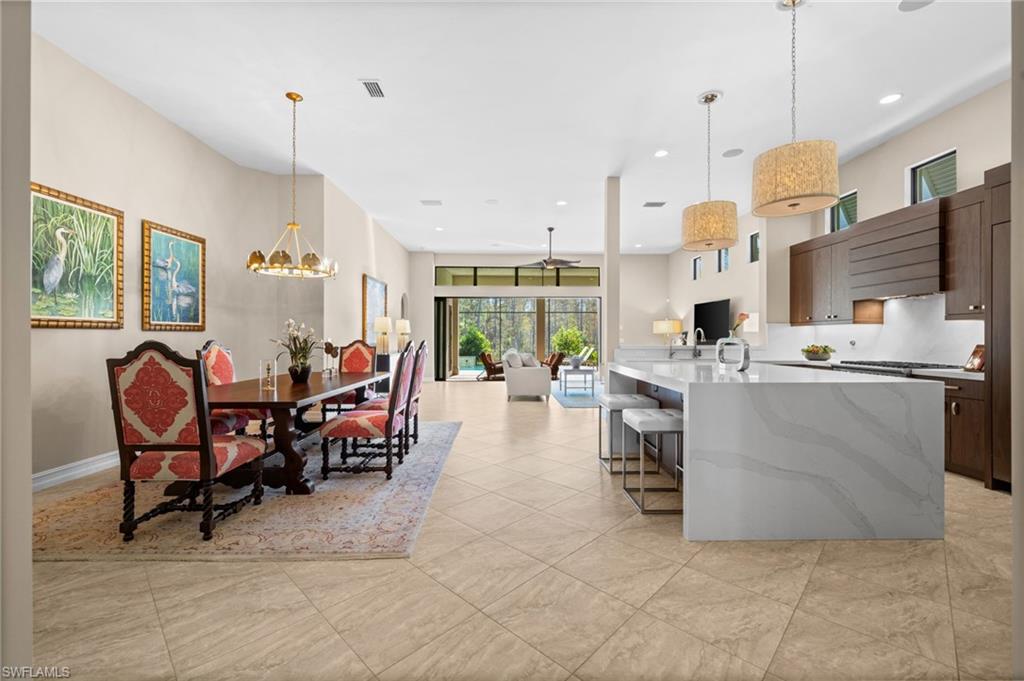 14686 Reserve Place Naples, FL 34109 - Photo 13 of 49 a large kitchen with a table and chairs