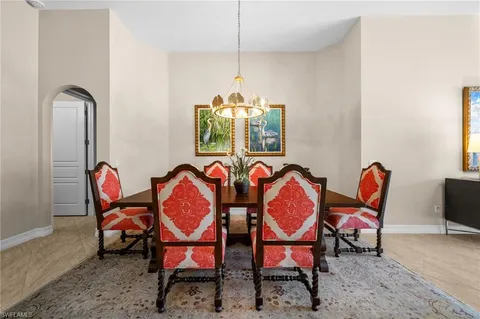 a dining room with furniture kitchen view and chandelier