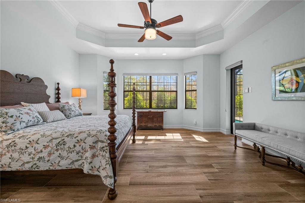 14686 Reserve Place Naples, FL 34109 - Photo 17 of 48 A serene primary suite filled with natural light and peaceful preserve views.