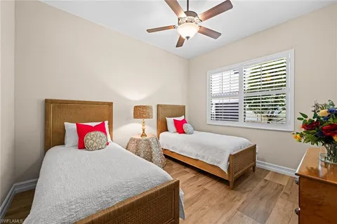 a bedroom with two beds and painting on the wall