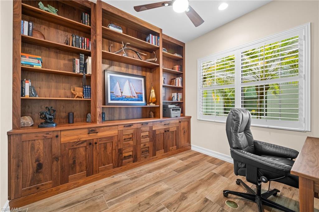 14686 Reserve Place Naples, FL 34109 - Photo 30 of 48 A stunning custom-built office with rich wood cabinetry and serene natural light.