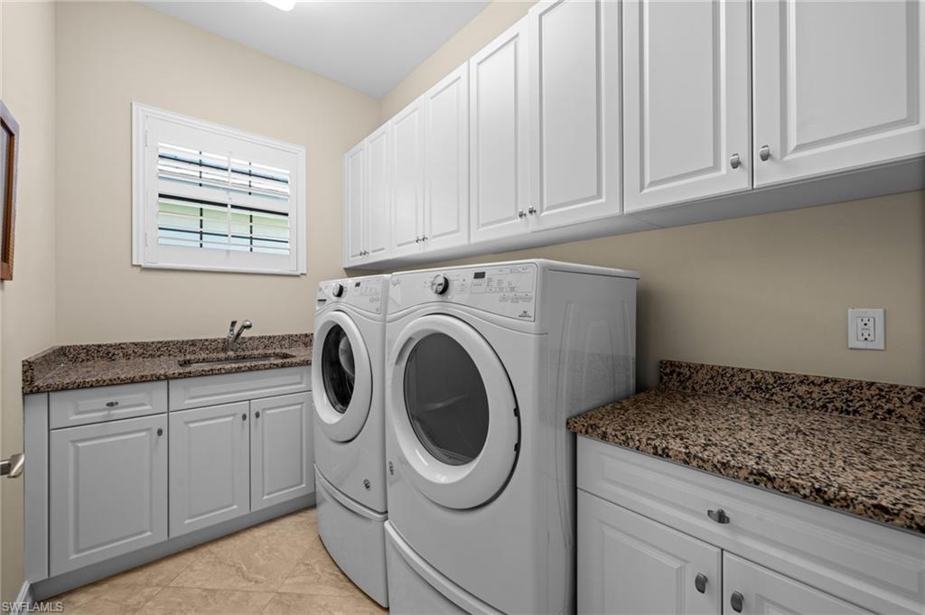 14686 Reserve Place Naples, FL 34109 - Photo 31 of 48 A spacious laundry room with abundant cabinetry and plenty of workspace.