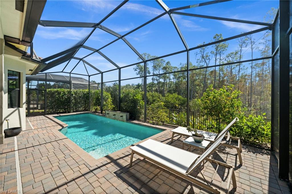 14686 Reserve Place Naples, FL 34109 - Photo 36 of 48 A screened enclosure covers the entire lanai and pool area.