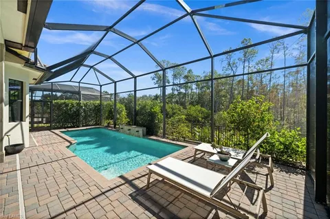 a view of a backyard with sitting area