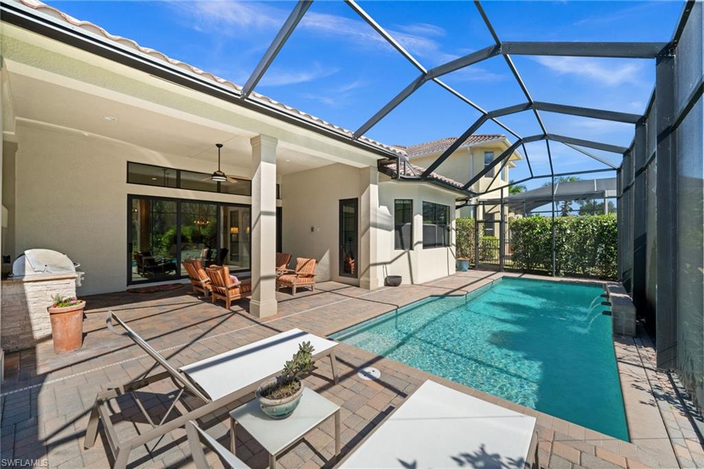 14686 Reserve Place Naples, FL 34109 - Photo 39 of 49 a view of a patio with table and chairs and potted plants