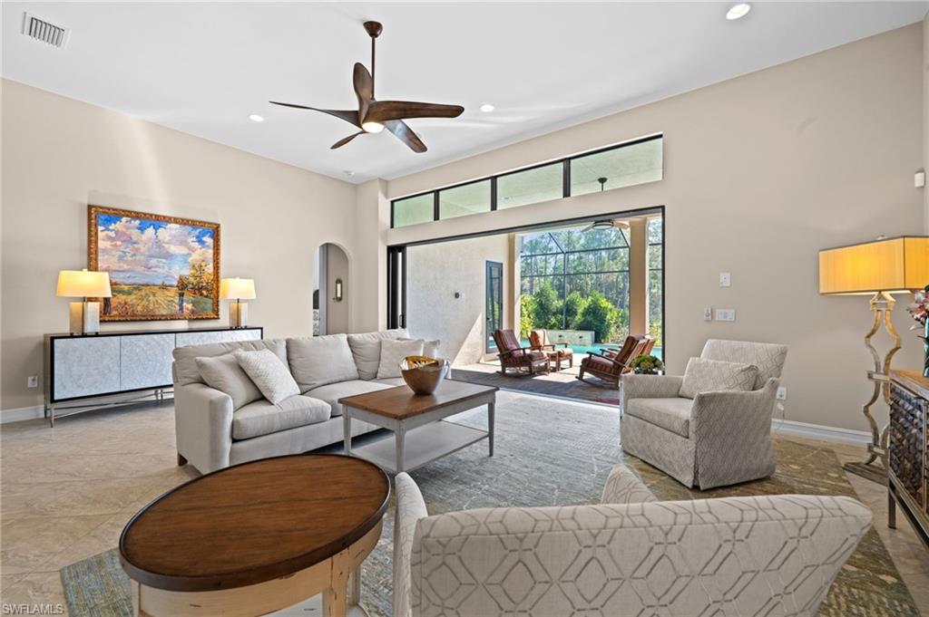 14686 Reserve Place Naples, FL 34109 - Photo 6 of 49 a living room with furniture and a large window