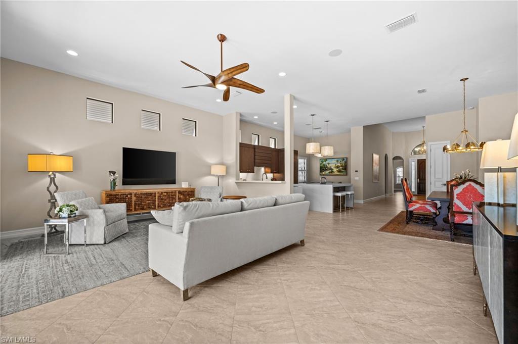 14686 Reserve Place Naples, FL 34109 - Photo 7 of 49 a living room with furniture and a flat screen tv