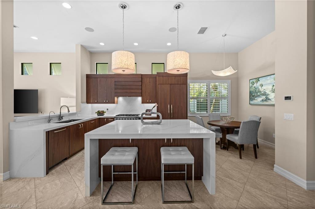 14686 Reserve Place Naples, FL 34109 - Photo 9 of 49 a kitchen with a table and chairs in it