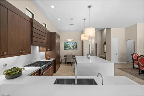 a kitchen with counter top space and living room
