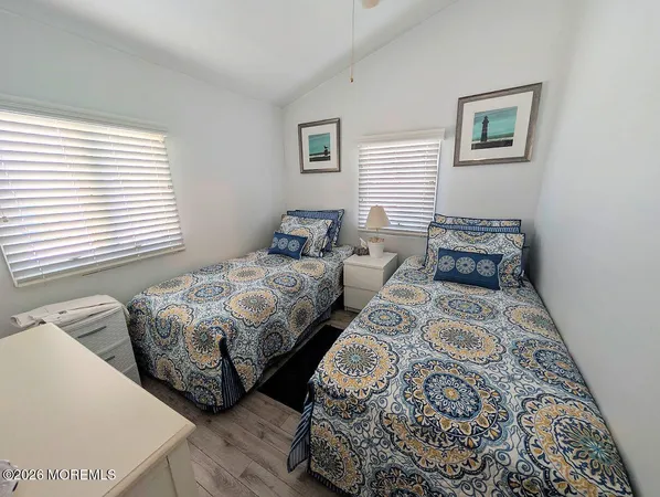 a bedroom with two beds and a window