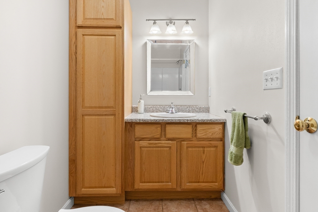188 Beach Road, Unit 15 Salisbury, MA 01952 - Photo 21 of 39 a bathroom with a granite countertop sink and a mirror