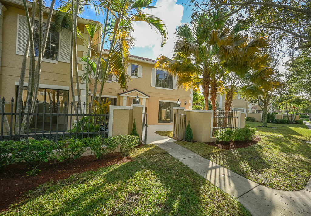 356 Prestwick Circle, Unit 3 Palm Beach Gardens, FL 33418 - Photo 1 of 42 a view of a house with a yard