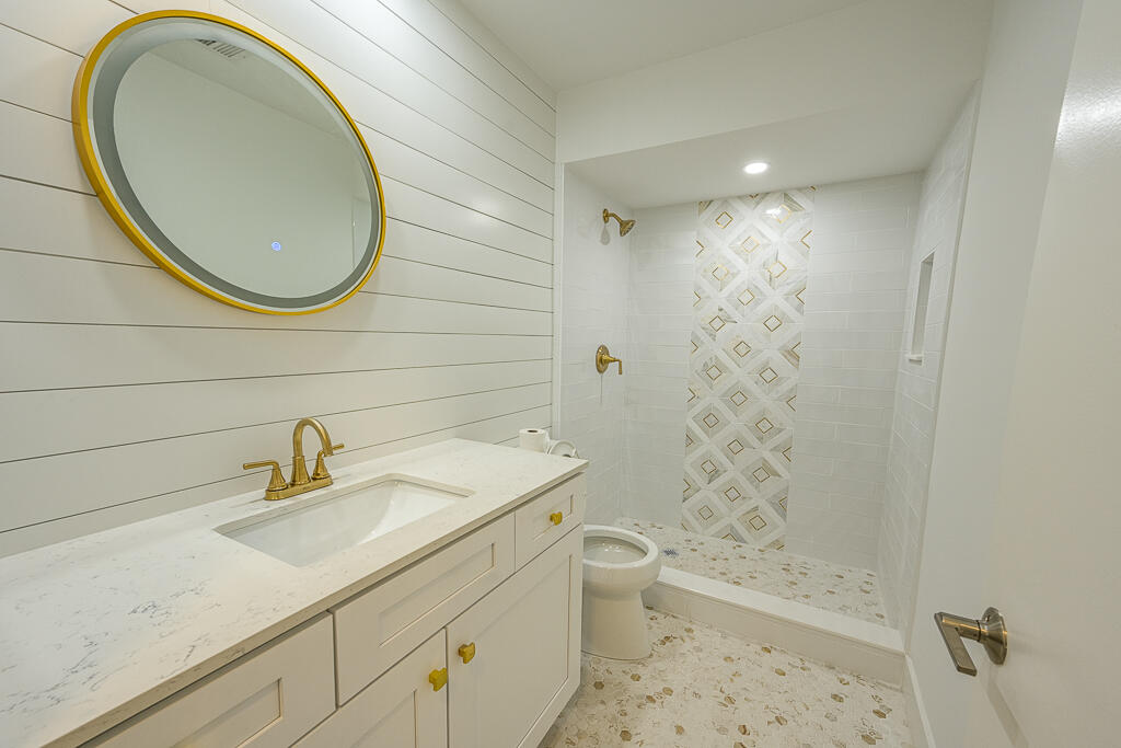 356 Prestwick Circle, Unit 3 Palm Beach Gardens, FL 33418 - Photo 11 of 42 a bathroom with a sink a toilet and shower