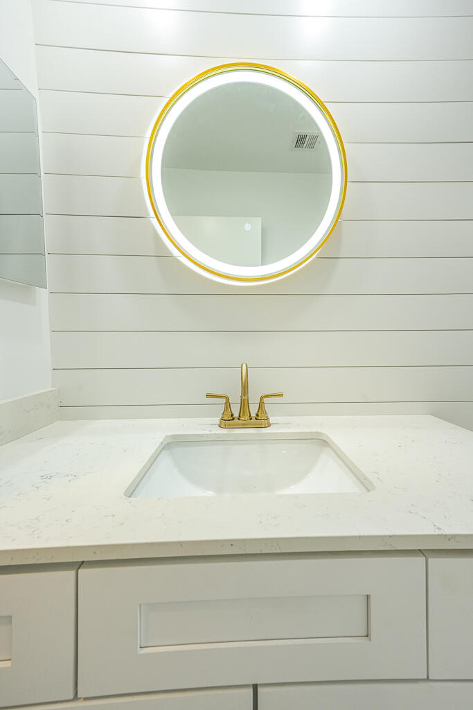356 Prestwick Circle, Unit 3 Palm Beach Gardens, FL 33418 - Photo 12 of 42 a bathroom with a sink and a mirror