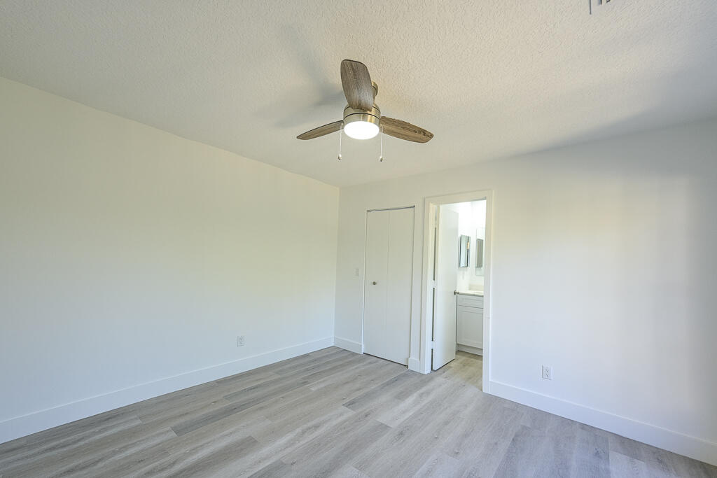 356 Prestwick Circle, Unit 3 Palm Beach Gardens, FL 33418 - Photo 21 of 42 a view of empty room with wooden floor