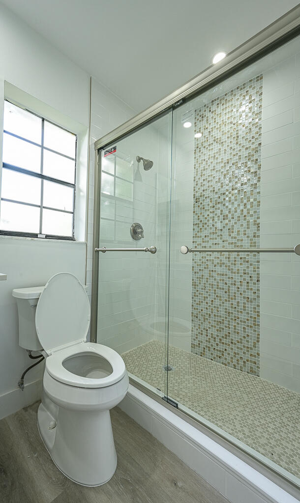 356 Prestwick Circle, Unit 3 Palm Beach Gardens, FL 33418 - Photo 31 of 42 a bathroom with a toilet and a shower