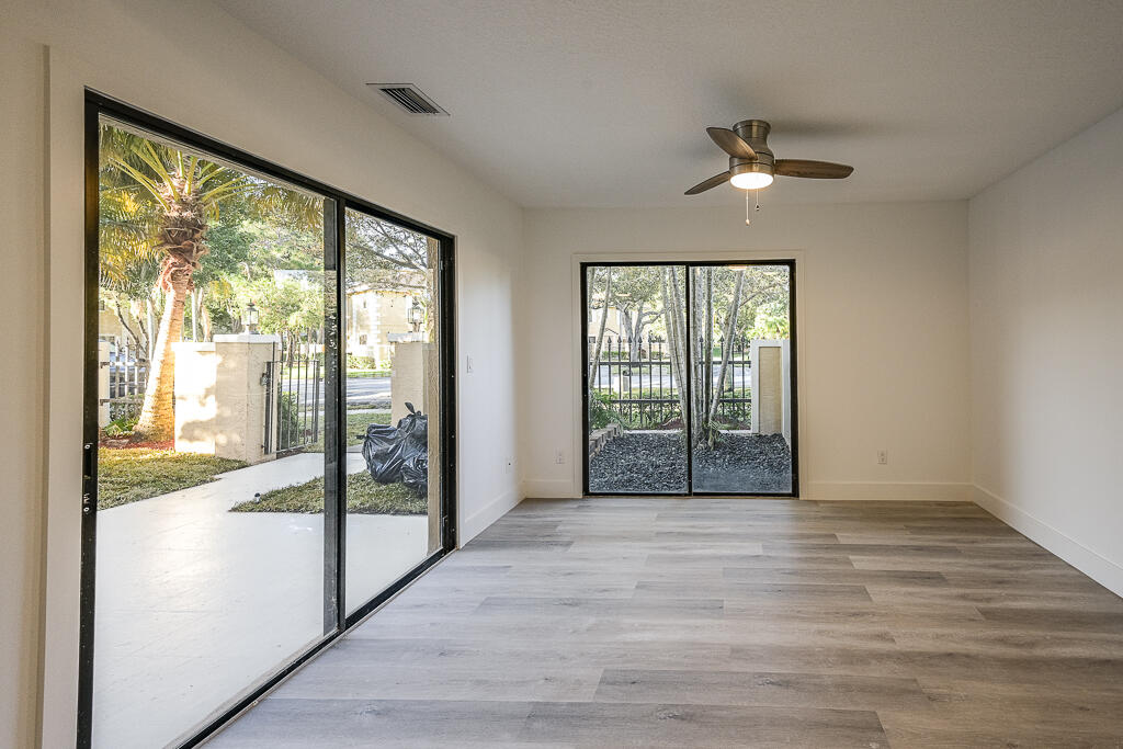 356 Prestwick Circle, Unit 3 Palm Beach Gardens, FL 33418 - Photo 7 of 42 a view of empty room with wooden floor and fan