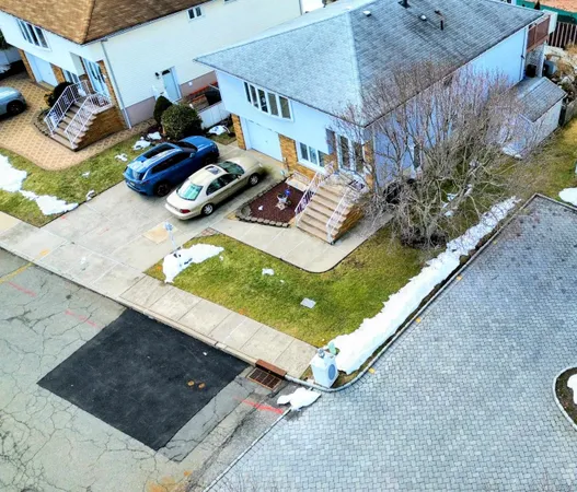 a view of a backyard with chairs and potted plants
