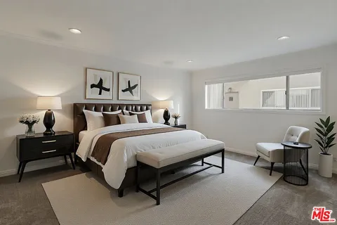 a bedroom with a bed and chair