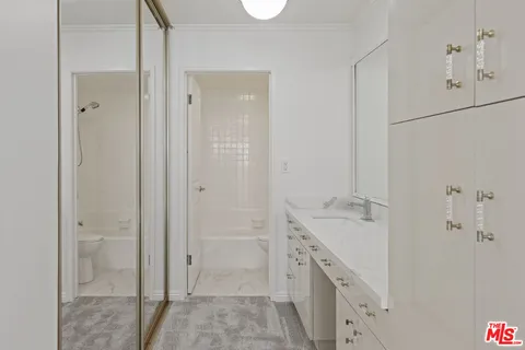 a spacious bathroom with a granite countertop sink a mirror and a shower