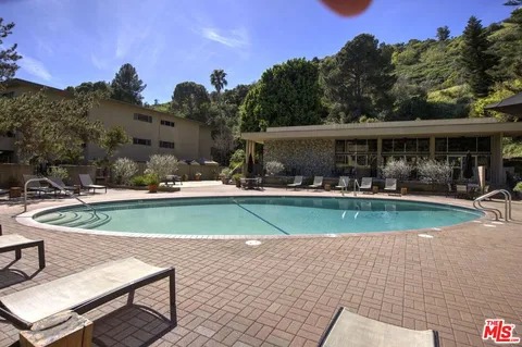 a view of a swimming pool with outdoor seating