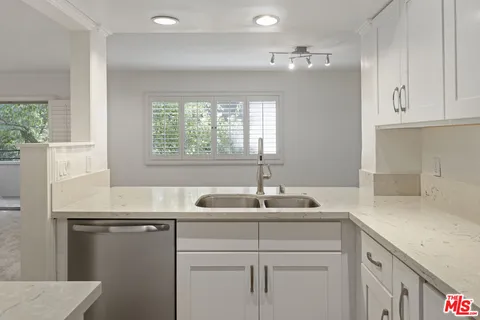a kitchen with a sink and a window