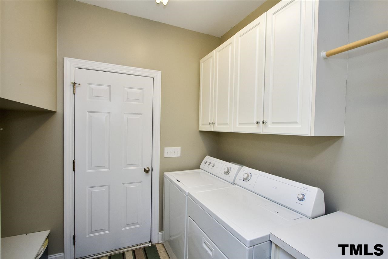 2012 Waterbrook Court Raleigh, NC 27603 - Photo 16 of 25 Fantastic first floor laundry room with cabinets, built-in shelves, and lots of space! Laundry