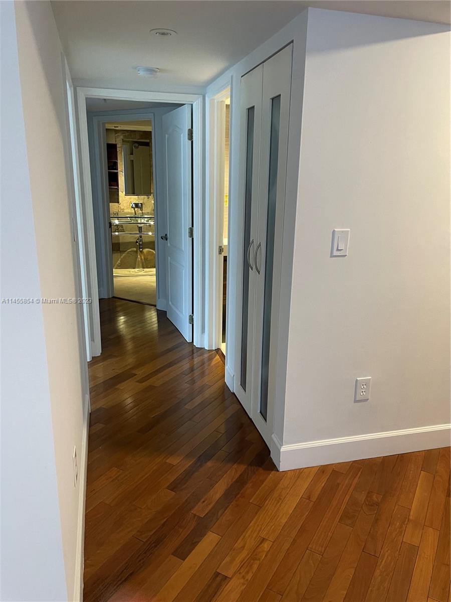 1900 Sunset Harbour Drive, Unit 1209 Miami Beach, FL 33139 - Photo 11 of 35 a view of a hallway with wooden floor and a bathroom