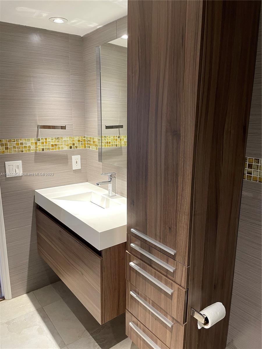 1900 Sunset Harbour Drive, Unit 1209 Miami Beach, FL 33139 - Photo 14 of 35 a bathroom with a sink and mirror