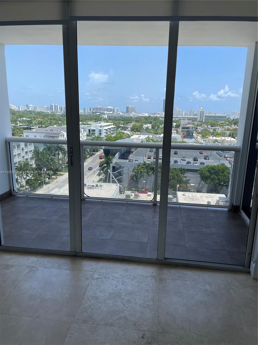 1900 Sunset Harbour Drive, Unit 1209 Miami Beach, FL 33139 - Photo 20 of 35 an empty room with wooden floor and large windows