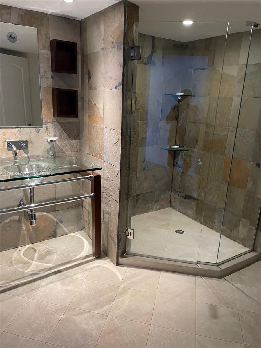 1900 Sunset Harbour Drive, Unit 1209 Miami Beach, FL 33139 - Photo 32 of 35 a bathroom with a sink and a shower
